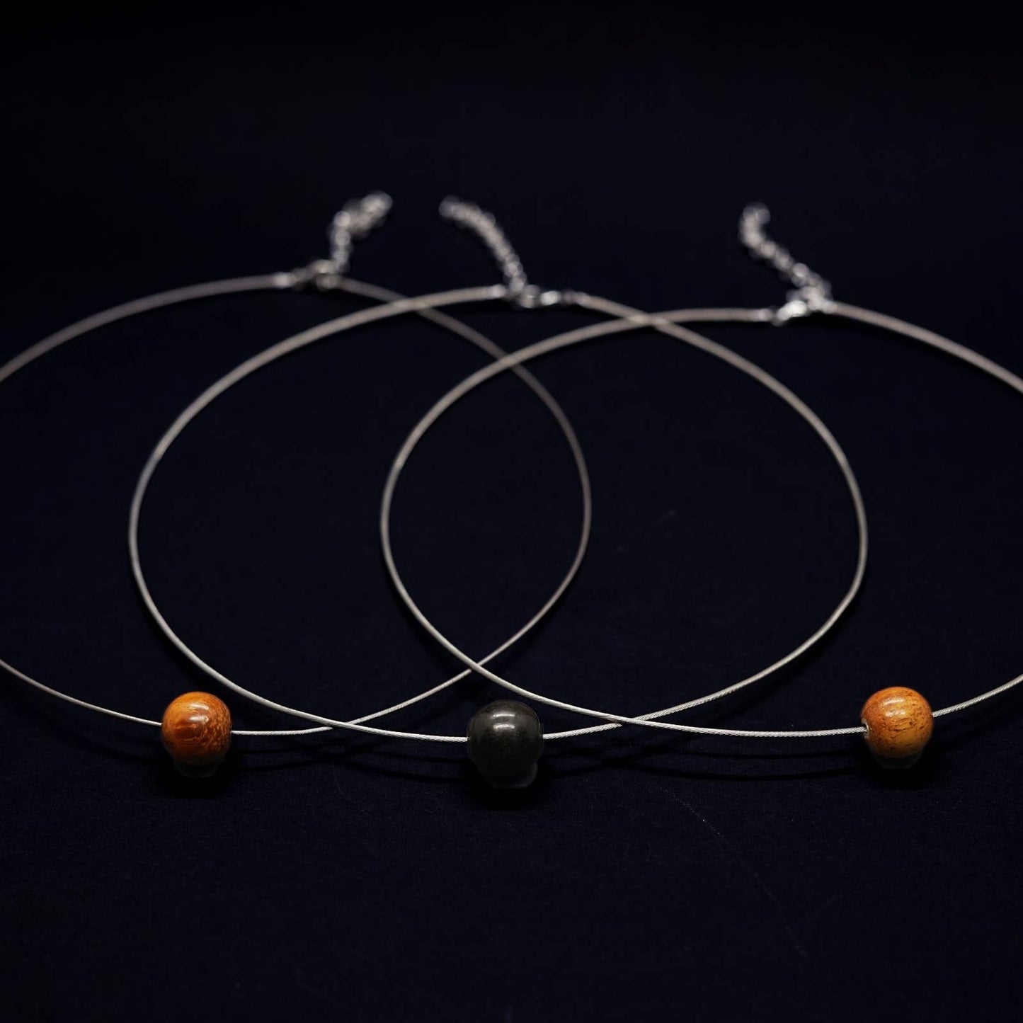 row of pretty silver cable necklace with wooden beads by silverwood jewellery