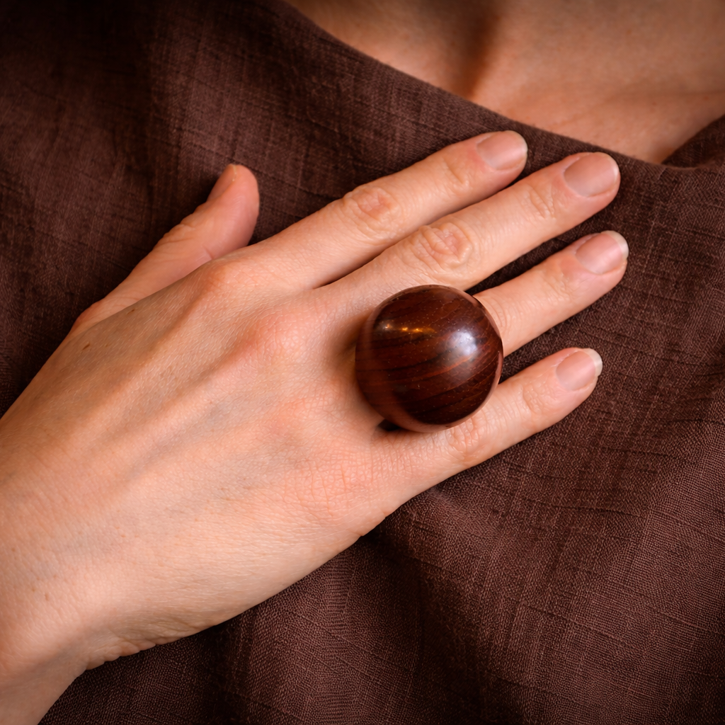 sculptural wood ring on woman's finer over linen top by silverwood