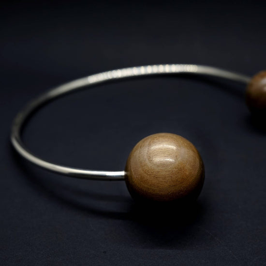 Load image into Gallery viewer, Giant wood sphere beads on sterling silver torque neck piece statement necklace by silverwood jewellery
