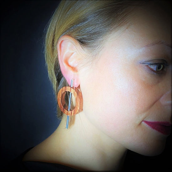 model wearing vegan statement wood and silver earrings with wood circle and silver tube by Silverwood Jewellery